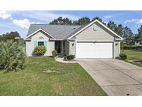 Charming single-story home with a manicured lawn, attached garage, and inviting curb appeal at 105 Windsor Springs Rd., Conway, SC 29526