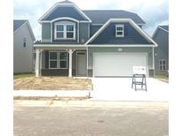 Charming two-story home with a well-manicured lawn and an attached two-car garage at 1095 Nw Forest Bend Dr., Calabash, NC 28467