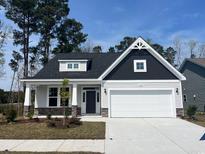 Charming single-story home with a two-car garage, stone accents, and a well-manicured lawn at 1105 Nw Forest Bend Dr., Calabash, NC 28467