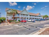 Spacious two-story condo building featuring ample parking, and well-maintained landscaping at 117 Butkus Dr. # 5, Myrtle Beach, SC 29588