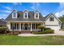 Charming home with three dormer windows, covered front porch, and landscaped yard at 120 Wraggs Ferry Rd., Georgetown, SC 29440