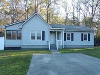 Charming single story home featuring a covered front porch and driveway at 1208 Mackie Circle, Myrtle Beach, SC 29579