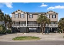 Inviting exterior elevation featuring tropical landscaping and stilt construction, ideal for coastal living at 1210 A S Ocean Blvd., Surfside Beach, SC 29575