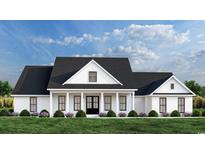 Charming modern farmhouse featuring black windows, a covered porch, and fresh landscaping at 1464 Hawthorn Dr., Pawleys Island, SC 29585