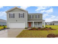 Charming two-story home with a two-car garage, lovely landscaping, and a cozy front porch at 147 Ashworth Dr., Tabor City, NC 28463