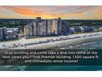 Stunning aerial view of a beachfront condo building with a sandy beach and ocean views at 1620 N Waccamaw Dr. # 1008, Garden City Beach, SC 29576