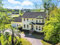 Charming two-story home with a well-manicured yard, inviting curb appeal, and a lovely palm tree at 205 Lander Dr., Conway, SC 29526