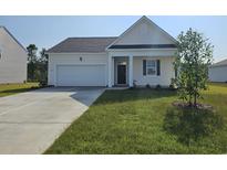 Charming single-story home featuring a two-car garage, well-maintained lawn, and classic architectural details at 316 Clear Lake Dr., Conway, SC 29526