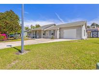 Charming single-story home with a well-maintained lawn, long driveway and attached two-car garage at 349 Robin Hood Circle, Little River, SC 29566