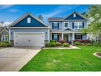 Charming two-story home with a well-manicured lawn, attached garage, and inviting entrance at 3613 Pitchers Pl., Little River, SC 29566