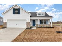 Charming two-story home featuring a 2-car garage, blue accents, and a welcoming front porch at 364 Hayloft Circle, Conway, SC 29526