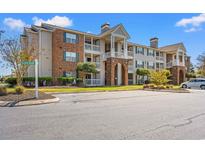 Attractive condo building featuring brick accents, balconies, and well-maintained landscaping at 3741 Block House Way # 736, Myrtle Beach, SC 29577