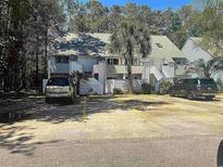 This lovely condo features a parking area and well-maintained landscaping, creating a welcoming atmosphere for residents and guests at 401 Cambridge Circle # A5, Murrells Inlet, SC 29576