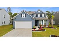 Charming blue two-story home featuring a two-car garage, black shutters, and manicured landscaping at 808 Wild Leaf Loop, Conway, SC 29526