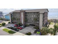 Multi-story condo with balconies and covered parking near the beach and landscaping at 811 N Ocean Blvd. # 401, Surfside Beach, SC 29575