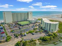 Beautiful aerial view of oceanfront resort featuring tennis courts, pool, and private beach access at 9400 Shore Dr. # 725, Myrtle Beach, SC 29572