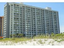 Beautiful exterior of a tall building with many balconies and a view of beach and grassy dunes at 9820 Queensway Blvd. # 607, Myrtle Beach, SC 29572