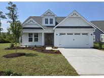 Charming single-Gathering home with a two-car garage, manicured lawn, and beautiful landscaping at 708 Lapwind Loop, Myrtle Beach, SC 29579