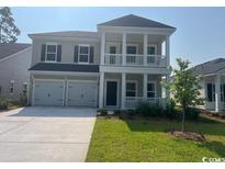Charming two-story home with a welcoming front porch and a two-car garage at 9738 Indigo Creek Blvd., Murrells Inlet, SC 29576