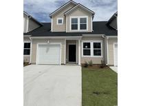 Charming townhome featuring a one car garage, neutral siding, and well-manicured lawn at 124 Hoffman Park Dr. # 01, Myrtle Beach, SC 29588