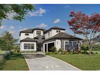 Stunning two-story home featuring a modern design, stone accents, and a well-manicured lawn at 1315 Ashboro Ct., Myrtle Beach, SC 29579