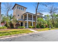 Stunning three-story home with double porches, manicured landscaping, and a charming coastal aesthetic at 138 Lumbee Circle # 17, Pawleys Island, SC 29585