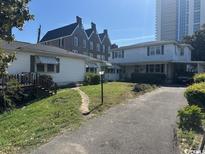 Property showing lawn and driveway, with a building in the background on a clear day at 1504 Chester St., Myrtle Beach, SC 29577