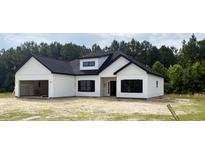 Charming new construction with a modern farmhouse design, black windows, and an attached two-car garage at 204 Shady Pines Ct., Conway, SC 29527