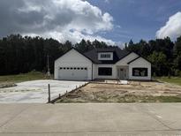 Charming new construction with white siding, black trim, and a spacious driveway at 204 Shady Pines Ct., Conway, SC 29527