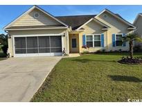 Charming single-story home featuring a screened garage, manicured lawn and welcoming curb appeal at 213 Cupola Dr., Longs, SC 29568