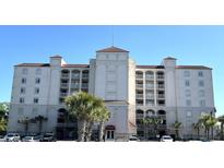 Exterior building view with Mediterranean-style architecture, balconies, and palm trees at Grande Dunes in Myrtle Beach, SC at 2151 Bridgeview Ct. # 3-305, North Myrtle Beach, SC 29582