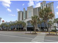 Attractive multi-story building, with palm trees, covered parking and beach access at 2401 S Ocean Blvd. S # 1256, Myrtle Beach, SC 29577