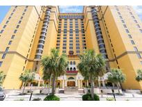 Grand hotel exterior featuring a welcoming entrance, bright facade, and verdant palm trees at 2600 N Ocean Blvd. # 1401, Myrtle Beach, SC 29577