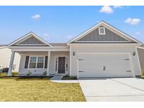 Charming single-story home with a two-car garage, well-maintained lawn, and inviting entryway at 3336 Little Bay Dr., Conway, SC 29526