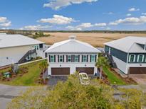 Beautiful waterfront home with a two-car garage and stunning marsh views at 35 Red Skiff Ln. # 35, Pawleys Island, SC 29585