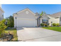 Charming single-story home with a well-manicured lawn, a two-car garage, and a lovely front yard at 363 Cypress Springs Way, Little River, SC 29566