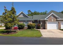 Charming brick home featuring a one-car garage, lush landscaping, and a well-maintained front yard at 400 Woodpecker Ln. # 17B, Murrells Inlet, SC 29576