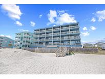Stunning multi-story oceanfront condo building with private balconies and easy beach access at 410 N Waccamaw Dr. # 306, Murrells Inlet, SC 29576