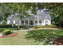 Charming two-story home with a well-manicured lawn and inviting front porch at 4218 Vanderbilt Dr., Pawleys Island, SC 29585