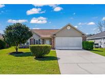 Charming single-story home featuring a well-maintained lawn, two-car garage, and attractive landscaping at 466 Wampee St. Nw, Calabash, NC 28467