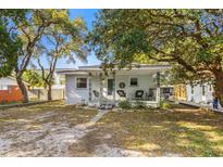 Charming single-story home featuring a welcoming front porch with classic rocking chairs and a well-manicured lawn at 505 19Th Ave. S, North Myrtle Beach, SC 29582