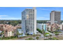 Beautiful exterior of a modern high-rise condo building with pool and palm trees at 5511 N Ocean Blvd. # 203, Myrtle Beach, SC 29577