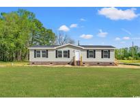 Charming single-story home with gray siding, black shutters, and a well-maintained lawn at 820 S Midway Hwy., Johnsonville, SC 29555