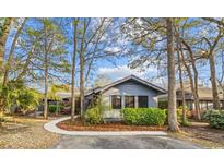 Charming single-story home featuring mature trees, landscaping, and a curved walkway leading to the entrance at 915 Cedarwood Circle, Myrtle Beach, SC 29572