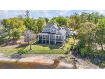 Stunning waterfront home featuring a spacious porch and lush landscaping at 1006 Surf Pointe Dr., North Myrtle Beach, SC 29582