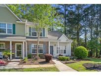 Charming townhome with brick accents, blue shutters, and a well-maintained front yard at 1064 Penny Ln. # 1064, Myrtle Beach, SC 29577