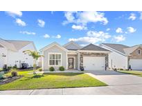 Charming single-story home featuring a stone-accented garage and beautifully manicured lawn at 1239 Pyxie Moss Dr., Little River, SC 29566