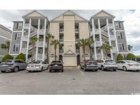 Condo exterior featuring multiple units, covered stairwells, and parking at 118 Ella Kinley Circle # 404, Myrtle Beach, SC 29588