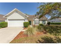 Charming single-story home with white siding, well-maintained landscaping, and an attached two-car garage at 1512 Hallborough Dr., Surfside Beach, SC 29575