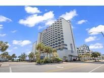 Modern condo building with balconies, palm trees, and beautiful blue skies at 2001 S Ocean Blvd. # 1303, Myrtle Beach, SC 29577